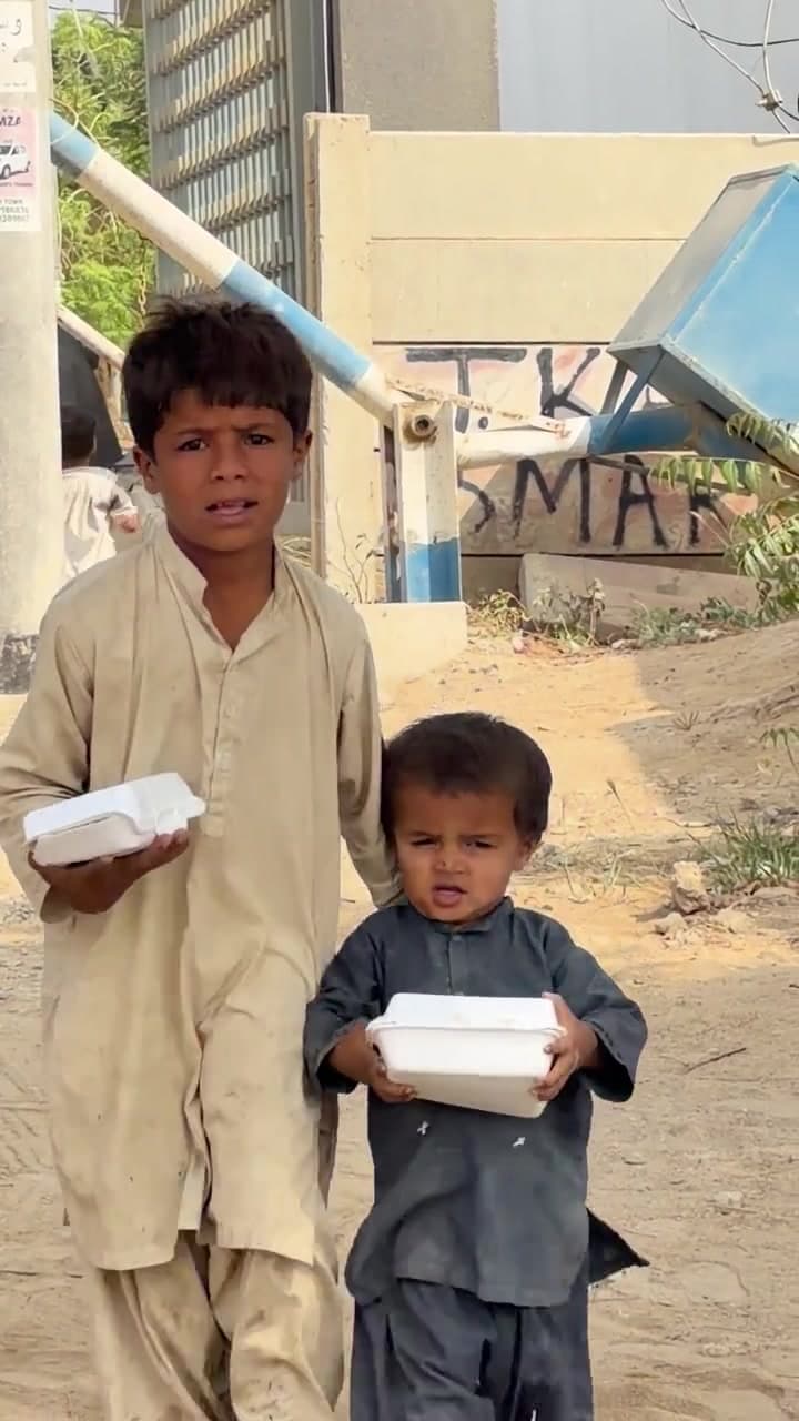 Two young boys holding their Sakina Legacy meal boxes